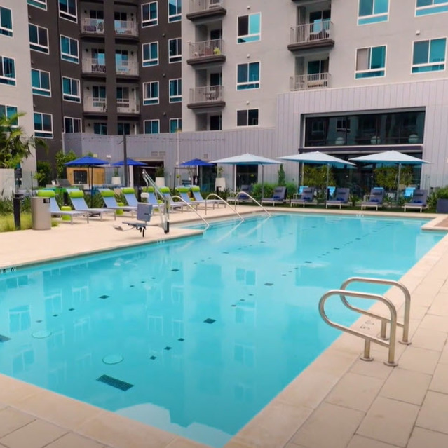 Pet-Friendly Apartments in Orange, CA - Avel - Pool with Lounge Chairs, Umbrellas, and Cabanas